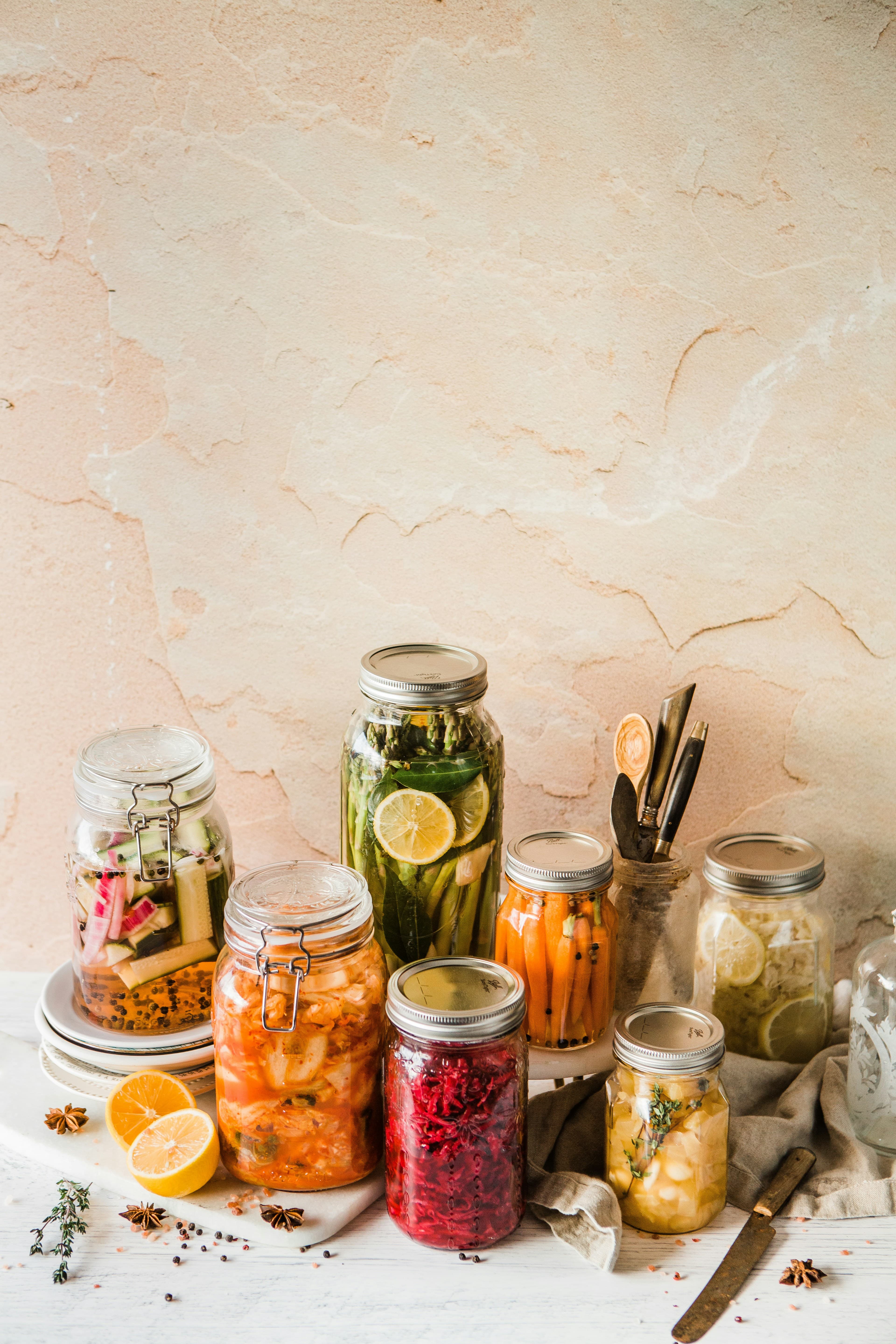 Colorful jars of homemade fermented vegetables — pickles, kimchi, sauerkraut, and carrots — beginner fermentation guide